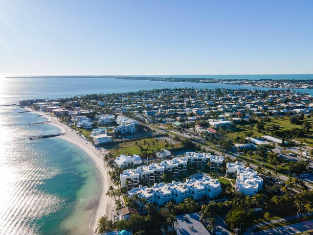 drone / aerial view featuring a water view and a beach view