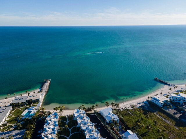 birds eye view of property with a water view and a view of the beach