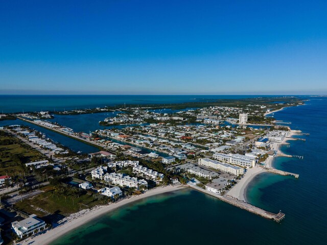 drone / aerial view with a water view, a view of city, and a view of the beach