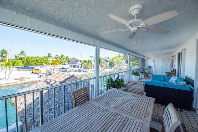 sunroom featuring ceiling fan