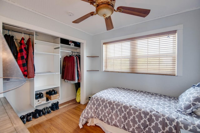 bedroom featuring a ceiling fan, a closet, and wood finished floors