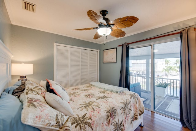 bedroom featuring access to exterior, visible vents, a closet, and ornamental molding