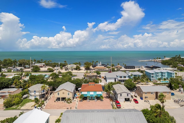 drone / aerial view featuring a residential view and a water view