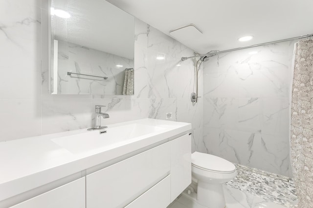 bathroom with toilet, recessed lighting, vanity, marble finish floor, and a marble finish shower