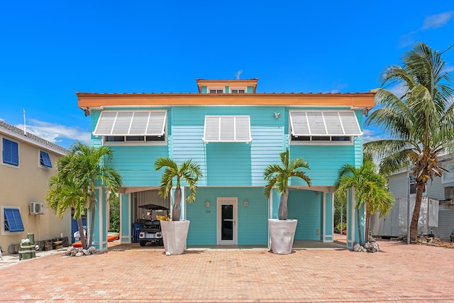 back of house featuring a carport