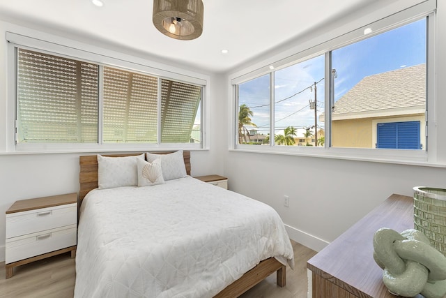 bedroom featuring recessed lighting, light wood-style flooring, and baseboards