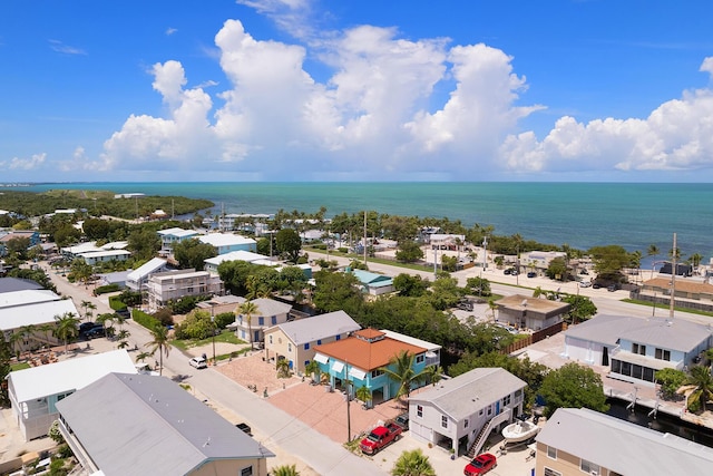 drone / aerial view with a residential view and a water view