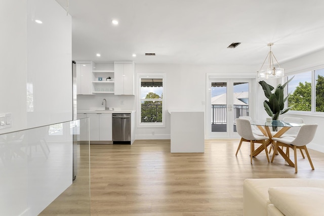 kitchen with white cabinets, light countertops, dishwasher, open shelves, and pendant lighting