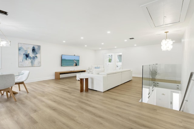 living room with baseboards, recessed lighting, visible vents, and light wood-style floors