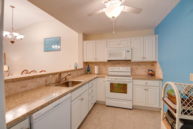 9867 Leeward Ave, Key Largo, FL 33037 - kitchen with white appliances, a sink, decorative backsplash, and white cabinetry