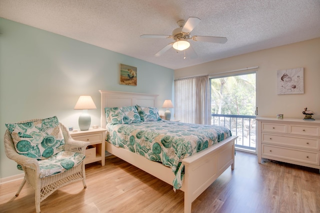 9867 Leeward Ave, Key Largo, FL 33037 - bedroom with access to exterior, light wood-style flooring, a textured ceiling, and a ceiling fan