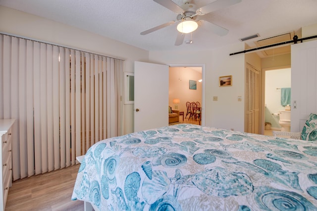 9867 Leeward Ave, Key Largo, FL 33037 - bedroom featuring light wood-style flooring, a ceiling fan, attic access, and connected bathroom