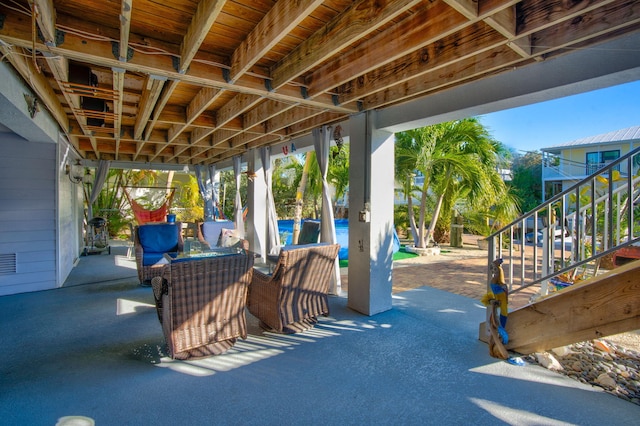 view of patio with an outdoor living space and stairway