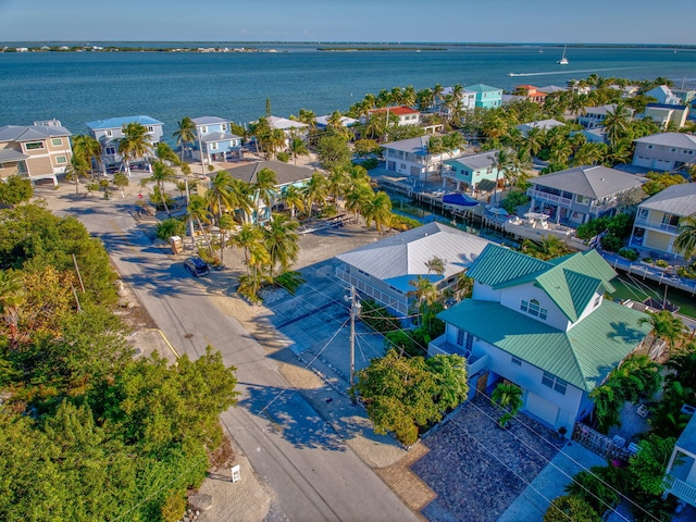 drone / aerial view featuring a residential view and a water view