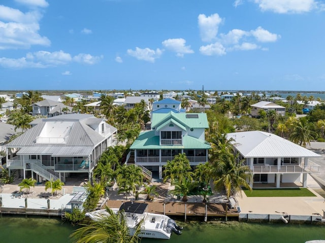 drone / aerial view featuring a residential view and a water view