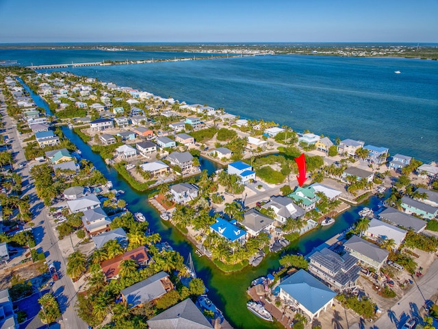 drone / aerial view featuring a water view and a residential view