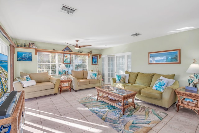 living area with visible vents, a ceiling fan, and light tile patterned flooring