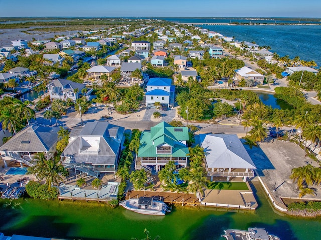 birds eye view of property with a water view and a residential view