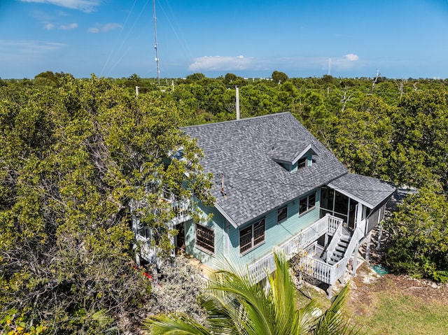 birds eye view of property featuring a view of trees