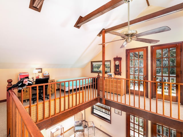 interior space with vaulted ceiling with beams, baseboards, and ceiling fan