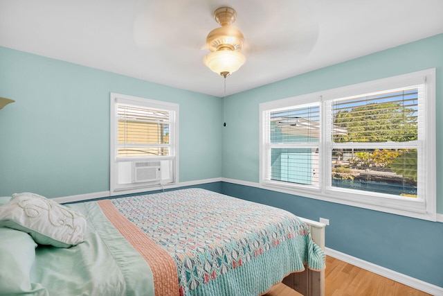 31034 Hollerich Dr, Big Pine, FL 33043 - bedroom featuring wood finished floors, cooling unit, and a ceiling fan