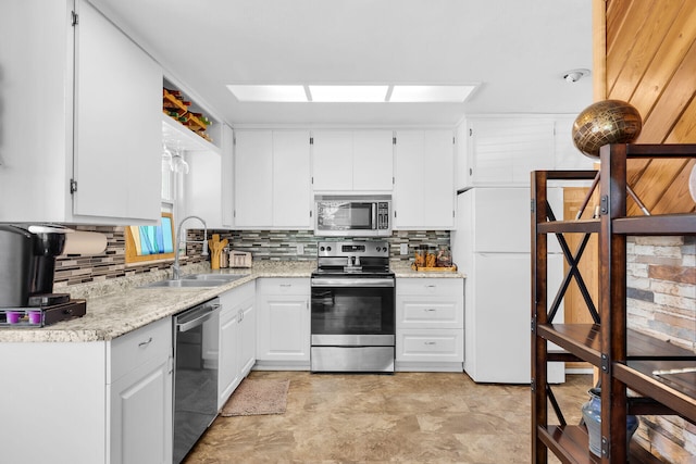 31034 Hollerich Dr, Big Pine, FL 33043 - kitchen featuring appliances with stainless steel finishes, backsplash, and white cabinetry