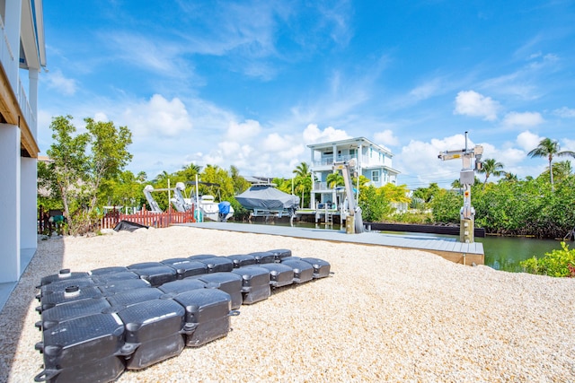 exterior space with a boat dock, a water view, and boat lift