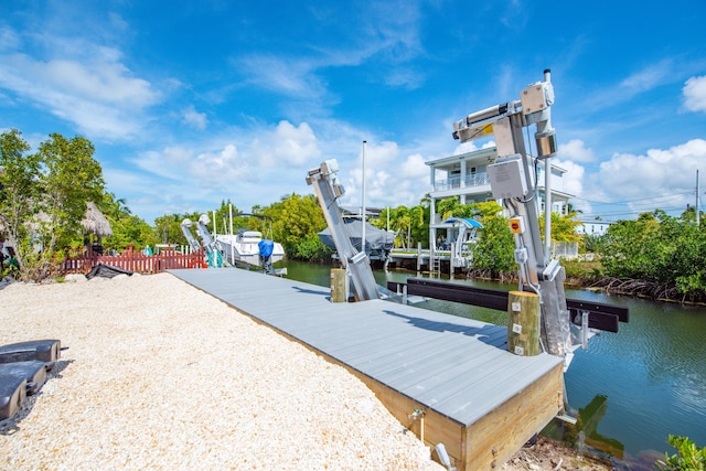 dock area with a water view and boat lift