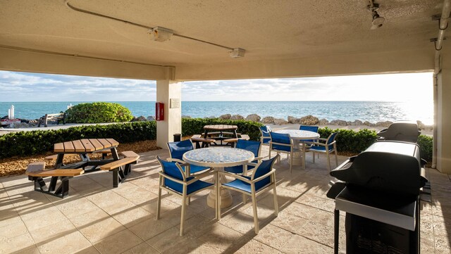 view of patio featuring outdoor dining space and a water view