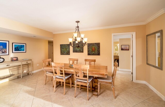 dining room featuring a chandelier, ornamental molding, and baseboards