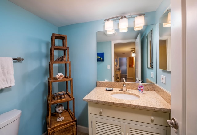 half bath featuring toilet and vanity