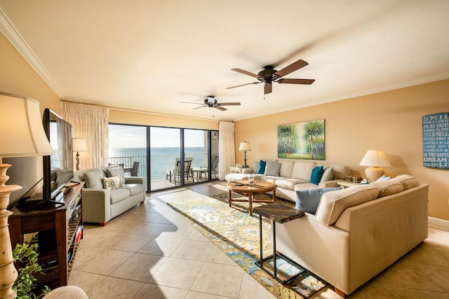 living area featuring light tile patterned flooring, a ceiling fan, and crown molding