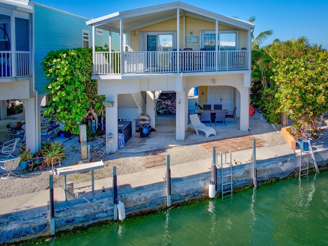 701 Spanish Main Dr Unit 77, Cudjoe, FL 33042 - back of property with a patio area, a water view, and a carport