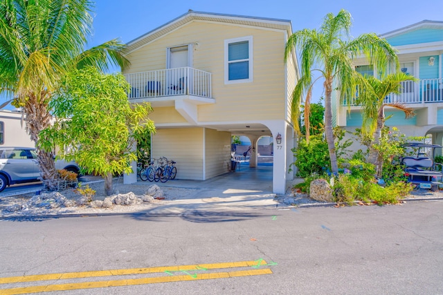 701 Spanish Main Dr Unit 77, Cudjoe, FL 33042 - view of front facade featuring a carport, driveway, and a balcony