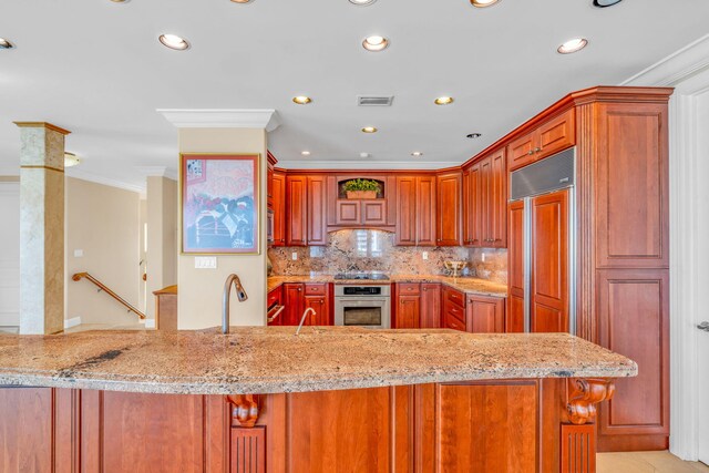 160 1st St, Key Colony, FL 33051 - kitchen featuring oven, crown molding, tasteful backsplash, recessed lighting, and light stone countertops