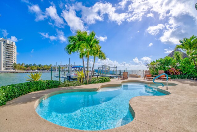 160 1st St, Key Colony, FL 33051 - outdoor pool featuring boat lift, a patio, a boat dock, and a water view