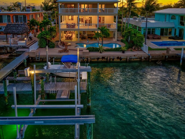160 1st St, Key Colony, FL 33051 - dock area featuring boat lift, a water view, an outdoor pool, and a patio area