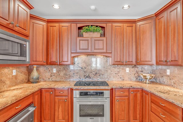 160 1st St, Key Colony, FL 33051 - kitchen featuring stainless steel appliances, backsplash, light stone counters, and recessed lighting