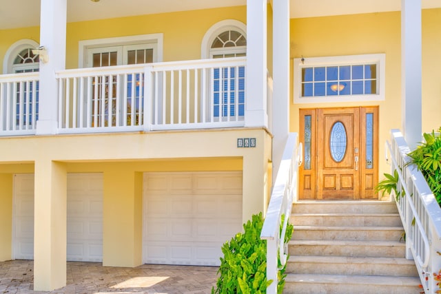 160 1st St, Key Colony, FL 33051 - property entrance featuring stucco siding, a garage, and driveway