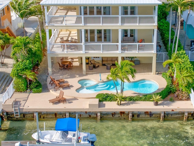 160 1st St, Key Colony, FL 33051 - back of property with a balcony, a patio, a pool with connected hot tub, and stucco siding
