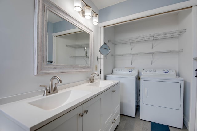 washroom featuring washing machine and dryer, laundry area, and a sink