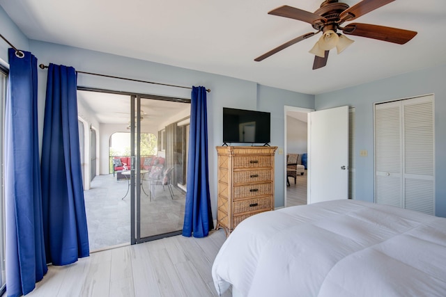 bedroom with access to exterior, wood finished floors, and a ceiling fan