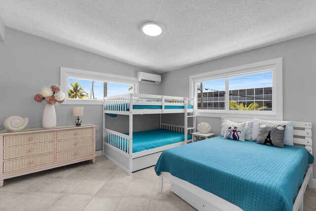 125 Cortez Dr, Islamorada, FL 33036 - tiled bedroom featuring a textured ceiling and a wall unit AC