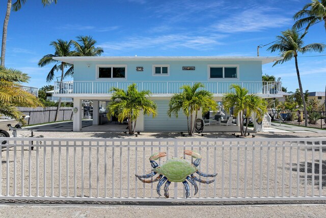 125 Cortez Dr, Islamorada, FL 33036 - beach home with a balcony and a fenced front yard