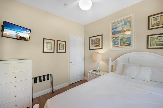 bedroom with baseboards and wood finished floors