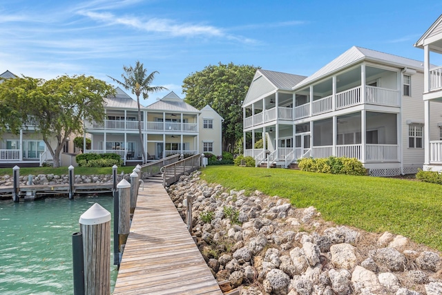 dock area featuring a balcony and a yard