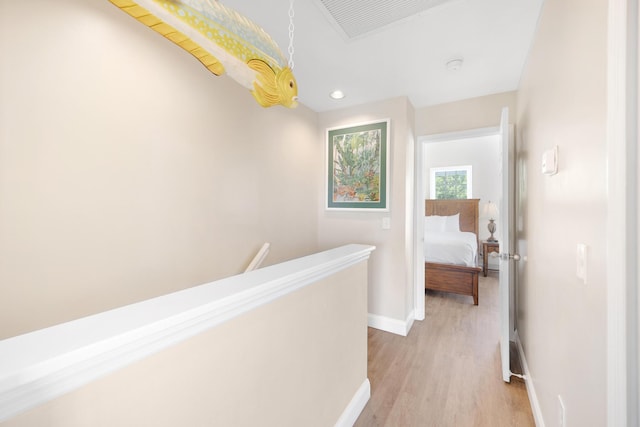 corridor with visible vents, an upstairs landing, recessed lighting, light wood-style floors, and baseboards