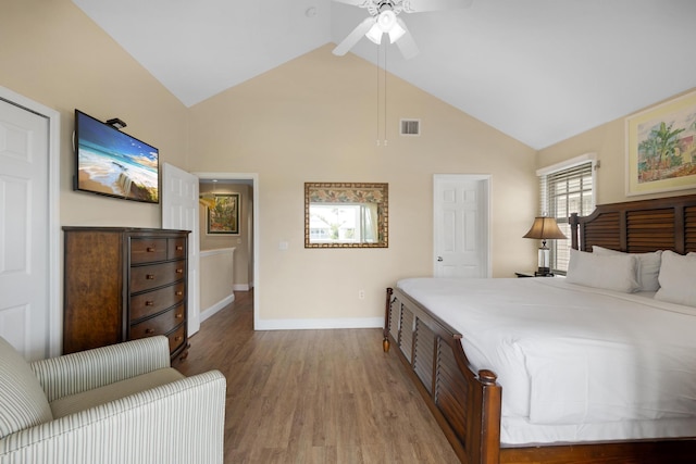 bedroom featuring visible vents, wood finished floors, baseboards, ceiling fan, and vaulted ceiling