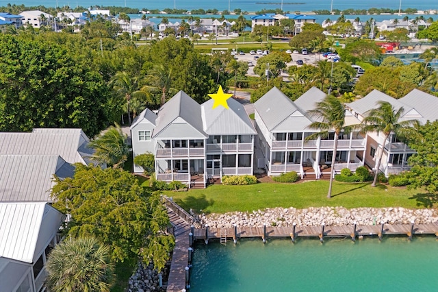 birds eye view of property with a residential view and a water view