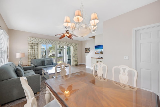 dining area with ceiling fan, baseboards, and wood finished floors